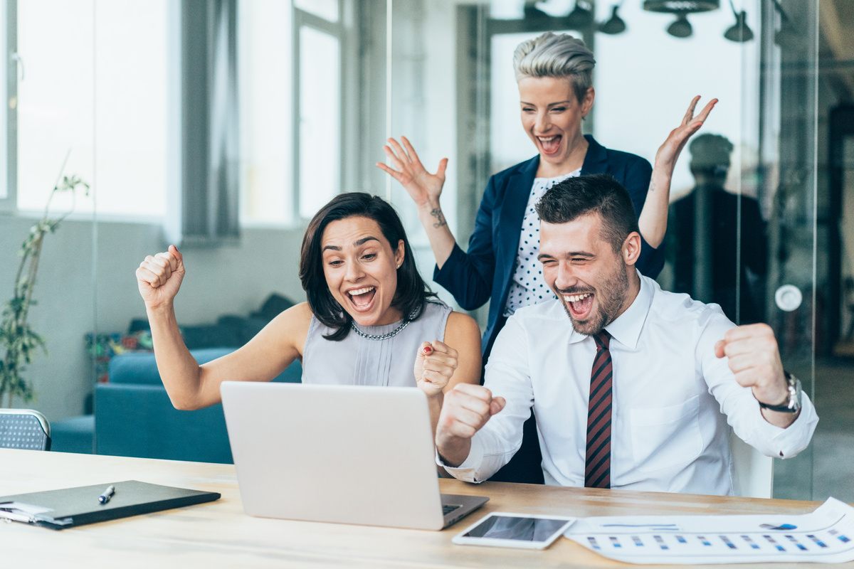 Three excited business persons